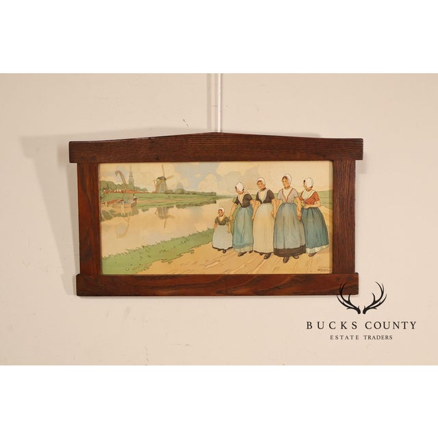 Charming framed print after Belgian artist Henri Cassiers, depicting a pastoral Dutch village scene with traditionally...