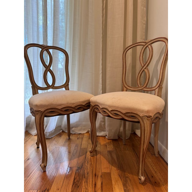 A set of ten late 19th century Italian dining chairs in the Louis XV taste, with sculptural interlaced backs, serpentine...