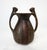 A vintage pre- Colombian styled painted terracotta pottery vase with geometric patterns and handles having the body and...