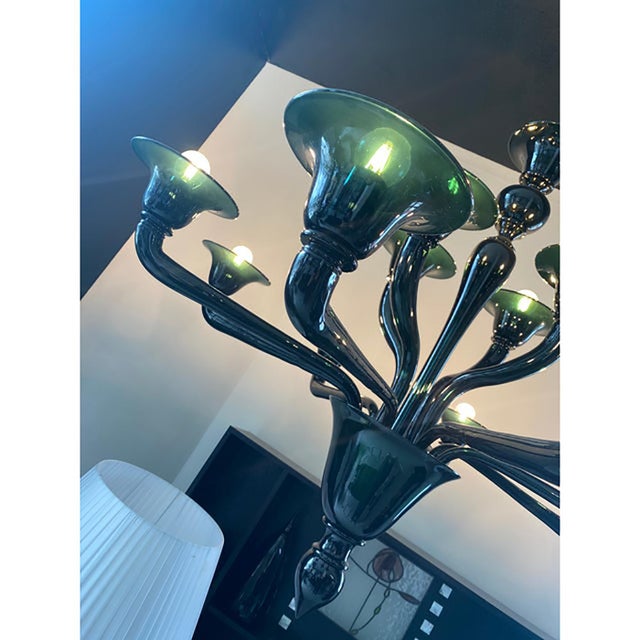 Contemporary murano glass chandelier in decò style decorated in green petrol colour which makes it extremely modern and...