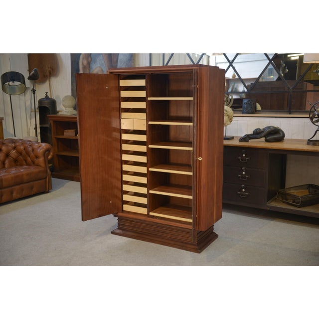 A very beautiful wooden wardrobe from the 1940s, with a simple and elegant design, highlighted by brass trim on the front....