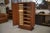 A very beautiful wooden wardrobe from the 1940s, with a simple and elegant design, highlighted by brass trim on the front....