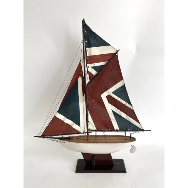 Handcrafted sailing ship with great detail and tiller/rudder that functions. It rests and can be removed from its wood...