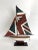 Handcrafted sailing ship with great detail and tiller/rudder that functions. It rests and can be removed from its wood...