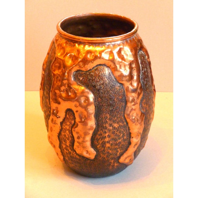 An ovoid vase in copperware by Jean Goardère, signed in relief under the neck, decorated with drips giving it a glossy...