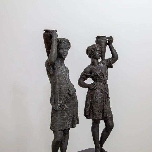 A pair of candlesticks made of cast zinc in figurative depiction, from the second half of the 19th century. Female: 37 x...