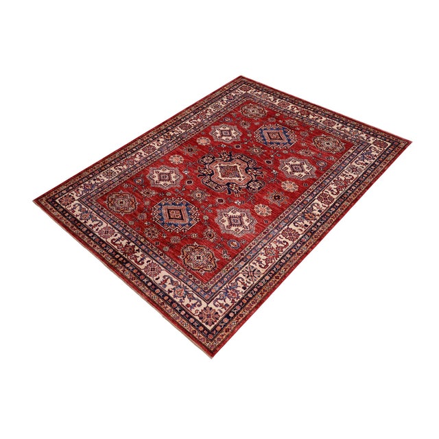 Enhance your home with this exquisite hand-knotted Super Kazak rug, crafted from fine hand-spun wool and dyed with all-...