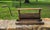 A vintage wooden clothes wringer, historically used for removing water from laundry, operates with a hand-cranked press...