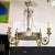 Neoclassical motif chandelier featuring gilt metal foliate arms, crystal beads, etched and frosted glass shade and...