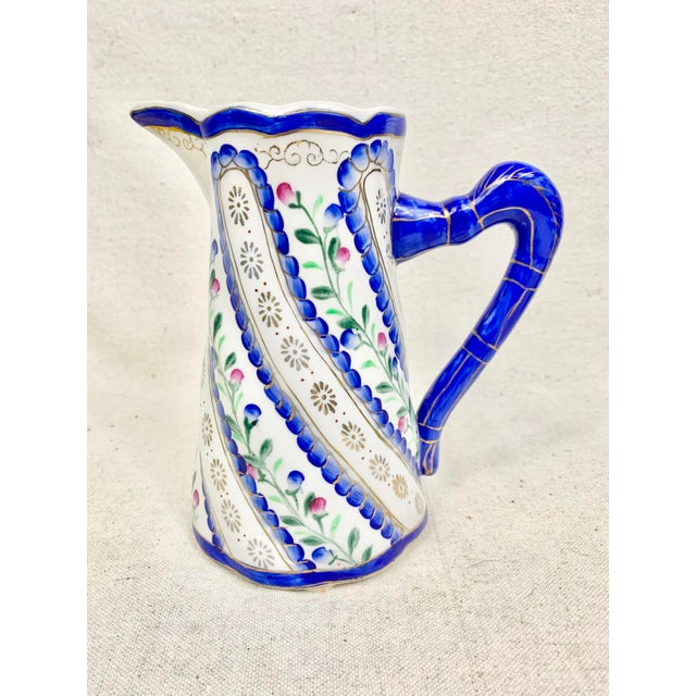 Vintage floral pitcher. Ceramic. Floral design with blue and gold details. Perfect for flowers or display- can not be used...