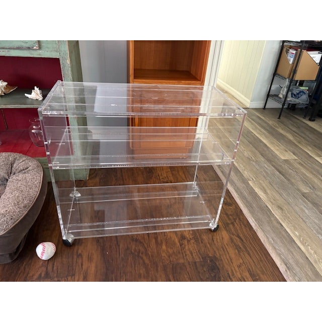 Modern acrylic serving cart or bar cart, made by AKKO in Massachusetts during the late 20th century. The piece has three...