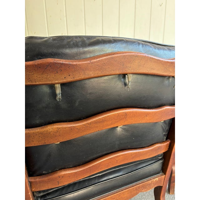 1950s-60s black leather/wood tufted side/occasional chairs; set of two. Some mild wear/aging to leather seats as shown,...