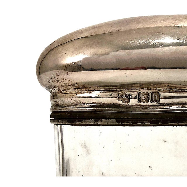 This exquisite item is an Edwardian sterling silver and cut-crystal vanity bottle. It features a double-lidded design with...