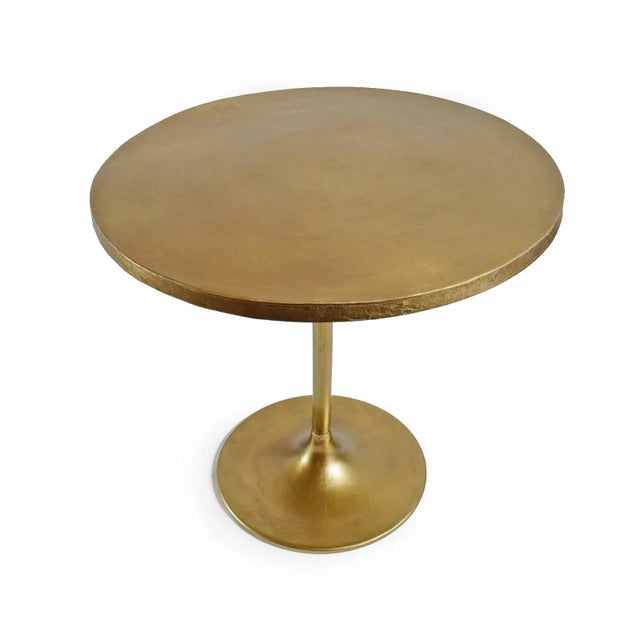 Beautiful cast aluminum round bistro table with antiqued brass finish. A solid brass appearance but lighter weight....