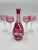 The Hutschenreuther Cranberry Overlay Crystal Wine Set features a decanter and 4 glasses made in Germany in the 1950s....