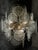 Striking Italian chandelier from the 1970s featuring numerous hand-formed clear Murano glass discs with distinctive...