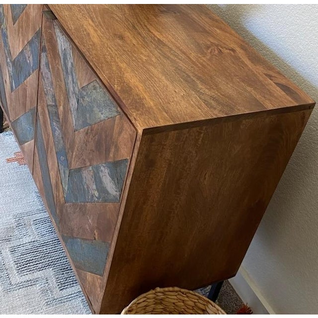 The Kaselstone Credenza, handcrafted using sustainable wood and stone accent in chevron pattern. 3 door soft close doors....
