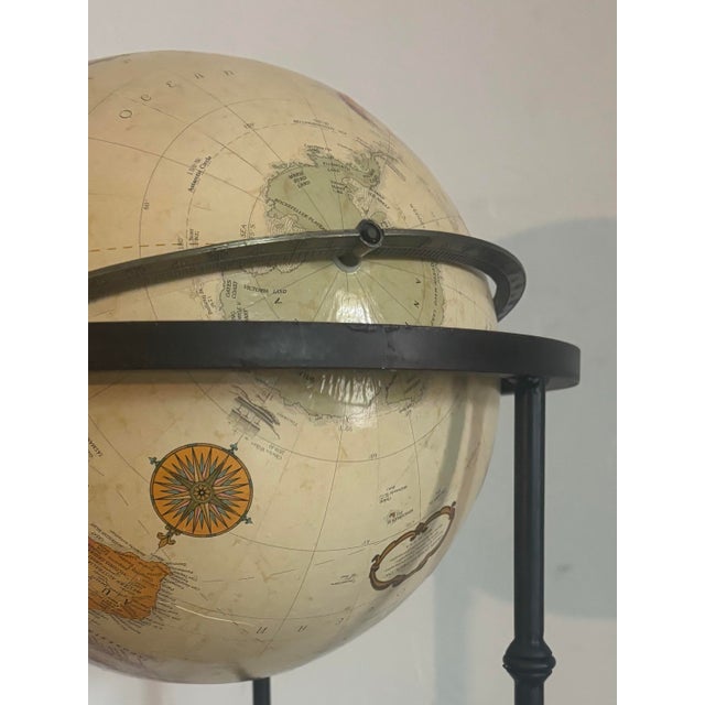 Vintage 12” replogle globe on wrought iron stand. Stand has a spindle/faux bamboo motif with decorations on each support....