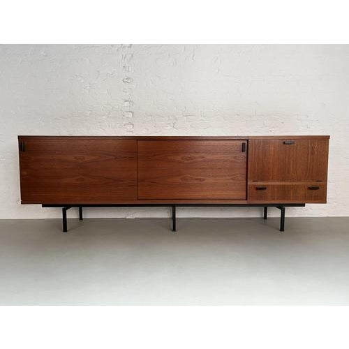 Large modernist sideboard produced in Belgium around 1960. Nice minimalistic design made of teak wood combined with a...