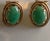Beautiful vintage earrings crafted in 14K yellow gold and set with polished oval jade cabochons. The jade stones display a...