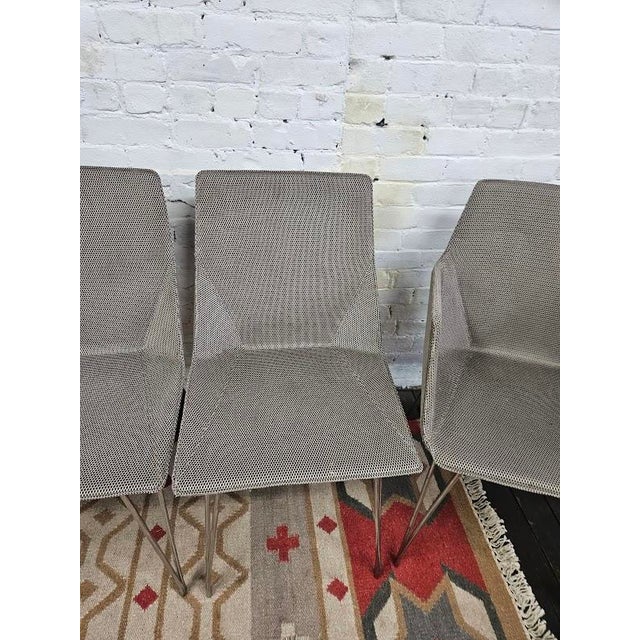 Bring high-end French design to your dining space with this set of contemporary dining chairs from the Ligne Roset/Cinna...