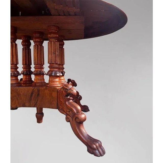 Mahogany pedestal table with a band resting on four legs supported by four columns. The table can be extended by you using...
