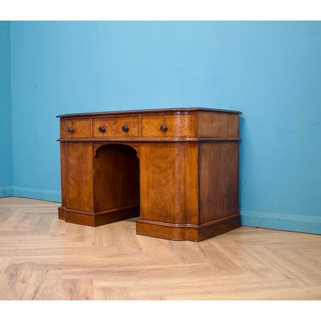 Victorian pedestal desk, c.1880, with a serpentine front and three drawers over a central kneehole. Fitted with two...