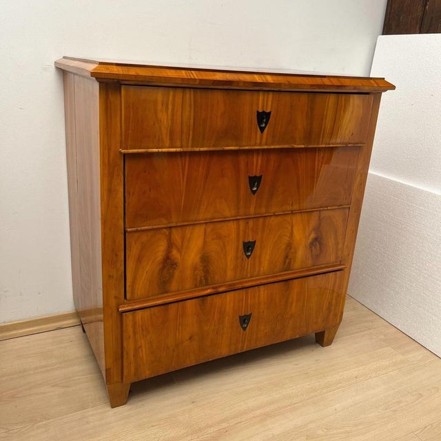 Beautiful, small 4-drawer Biedermeier Commode or Chest of drawers in cherry wood from South Germany, circa 1830. Cherry...