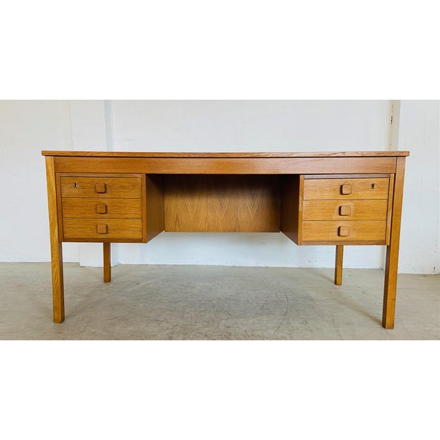 An exceptional Danish Modern desk designed and manufactured by Domino Møbler during the 1960s. Crafted from beautiful oak,...