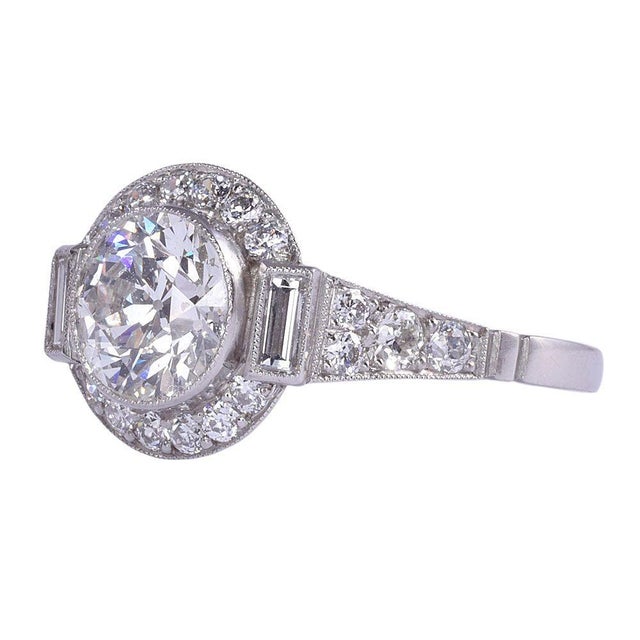 Antique 1.33 carat center diamond platinum engagement ring, circa 1900. This antique engagement ring features a 1.33 carat...