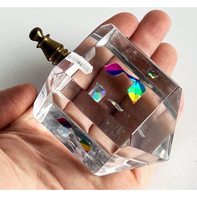 This charming lucite dreidel features a faceted clear body with a colorful, prismatic design to the hebrew characters,...
