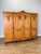 An impressive Vintage French Louis wardrobe in oak, featuring four beautifully shaped panelled doors enriched with...