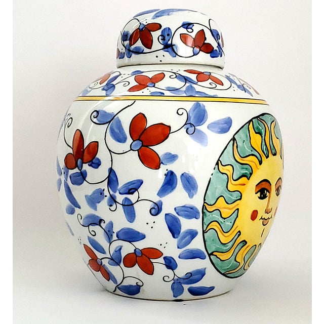Offering a vintage Chinese porcelain ceramic ginger jar, circa 1970s. It is hand painted with colorful faces of the sun on...