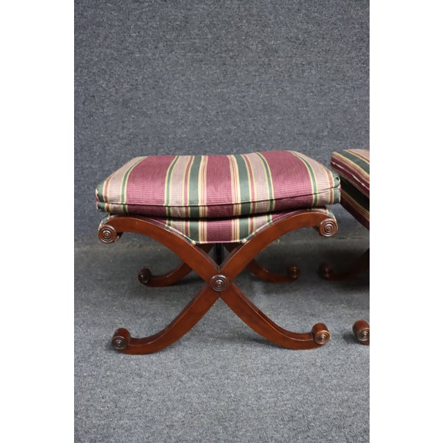 A beautifully crafted pair of X-base stools by Hickory Chair Company, featuring an elegant form inspired by traditional...