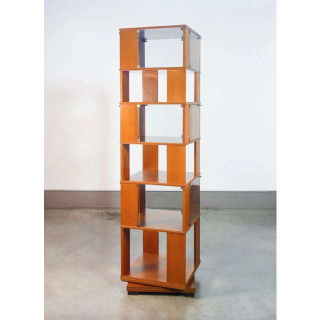 Swivel library from the wooden center, six shelves, three of which with glass doors. Origin Italian design period 60s...