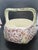 vintage ceramic basket features an embossed purple and white floral pattern with a sculpted twig-style handl