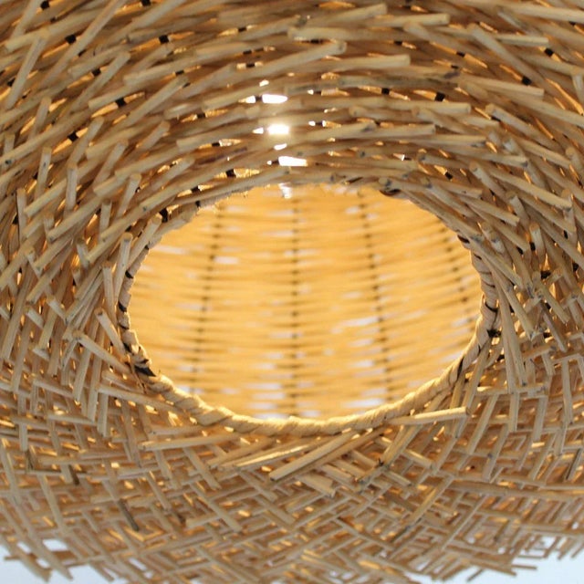 Hand woven raw rattan sticks shaped into an interesting bird nest shaped lantern. This beautiful and unique light fixture...
