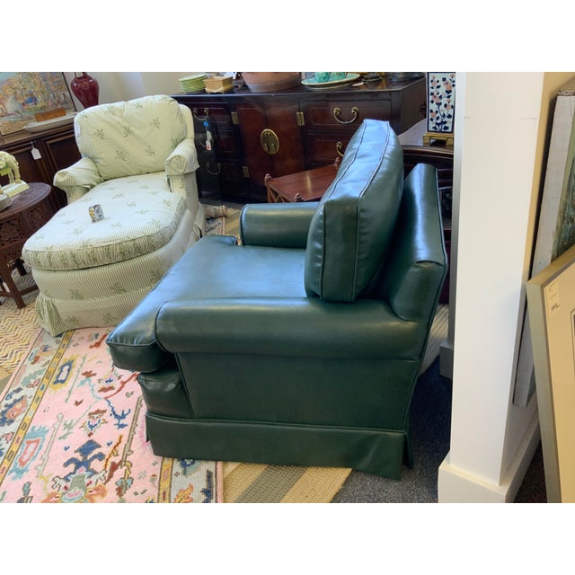 Green vinyl club chair with skirted detail. Nice size and comfortable. would fit with most decor and style expressions.