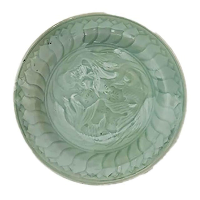 Set of 4 Chinese Celadon pottery plates depicting embossed koi fish swimming in a circle. The images have been contrasted...