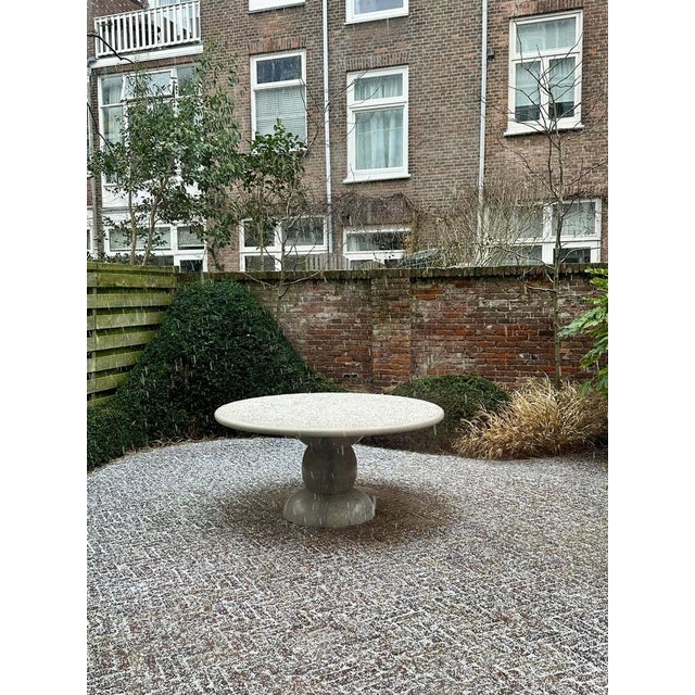 This minimalist outdoor table is made from one material, featuring a sculptural base, giving this table an organic feel...