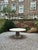 This minimalist outdoor table is made from one material, featuring a sculptural base, giving this table an organic feel...