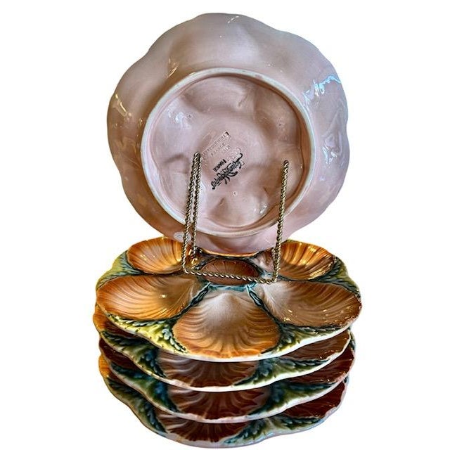 Beautiful French majolica oyster plate in lustrous deep coloring., circa 1875-1900. Six scallop shaped wells surround a...