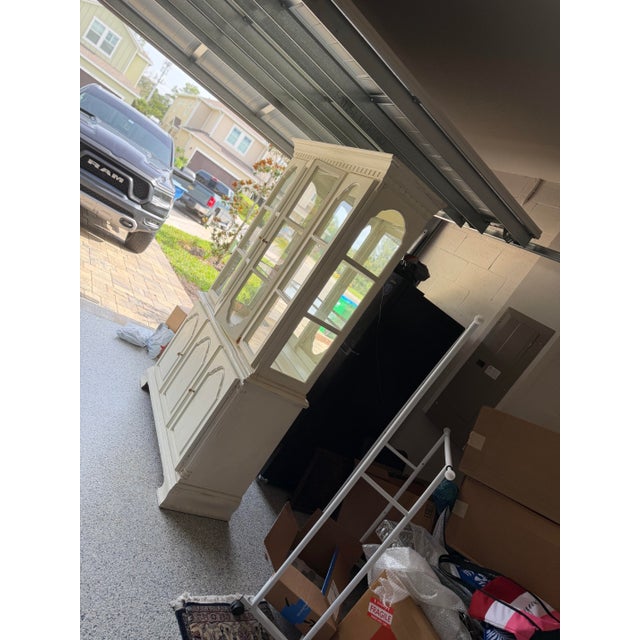 Elegant vintage china cabinet and buffet by Dixie Furniture, featuring classic French Provincial styling and a warm cream...
