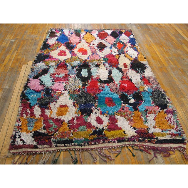 Antique / Vintage Mid Century Moroccan Boucherouitte wool multicolor area rug, Circa Date: 1940s. This vibrant example of...