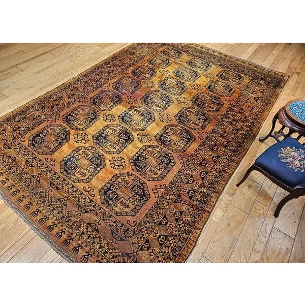This authentic vintage Afghan Ersari room-size rug features a classic allover geometric composition woven in a highly...
