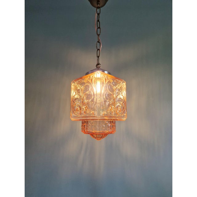 Art Deco pendant light in pale pink pressed molded glass with a chrome-plated metal frame, circa 1920-30. Pretty floral...