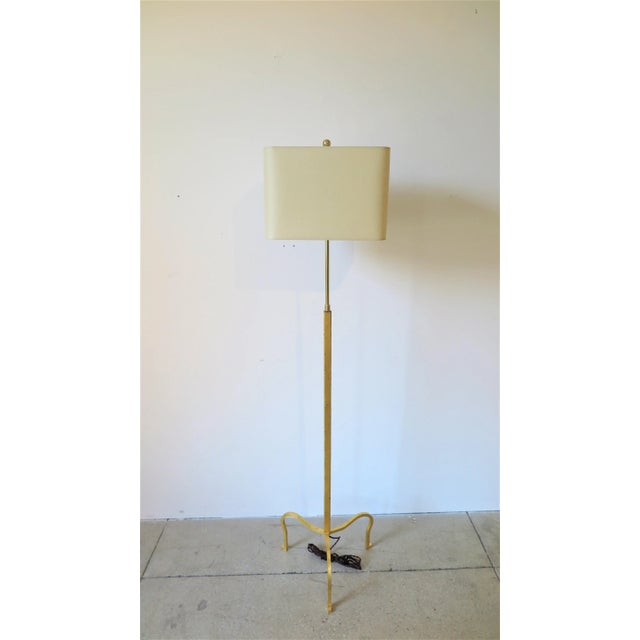 Tripod adjustable 24-karat gold leaf gilded floor lamp attributed to Albert Hadley and Pairish Hadley Design. Pair...