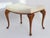 Antique English wooden foot stool with an elegant white fabric. The stool is standing on wooden cabriole legs. Made out of...