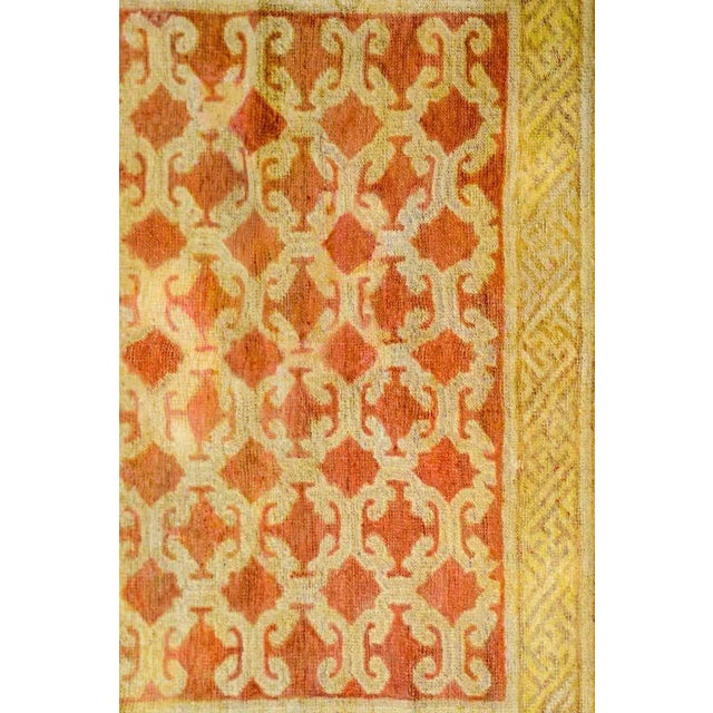 An unusual early 20th century Central Asian Khotan rug with a knotted lattice pattern woven in a cream colored wool on a...