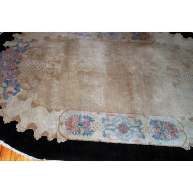 Handmade antique oval Art Deco Chinese rug in light brown shade with black border. The rug is in original good condition....